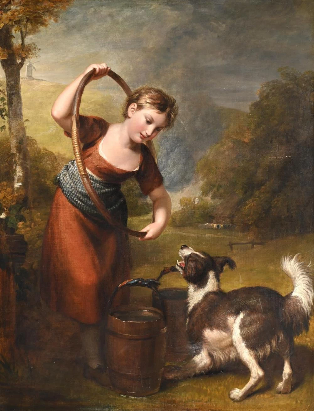 Una ragazza con un cerchio ed un cane